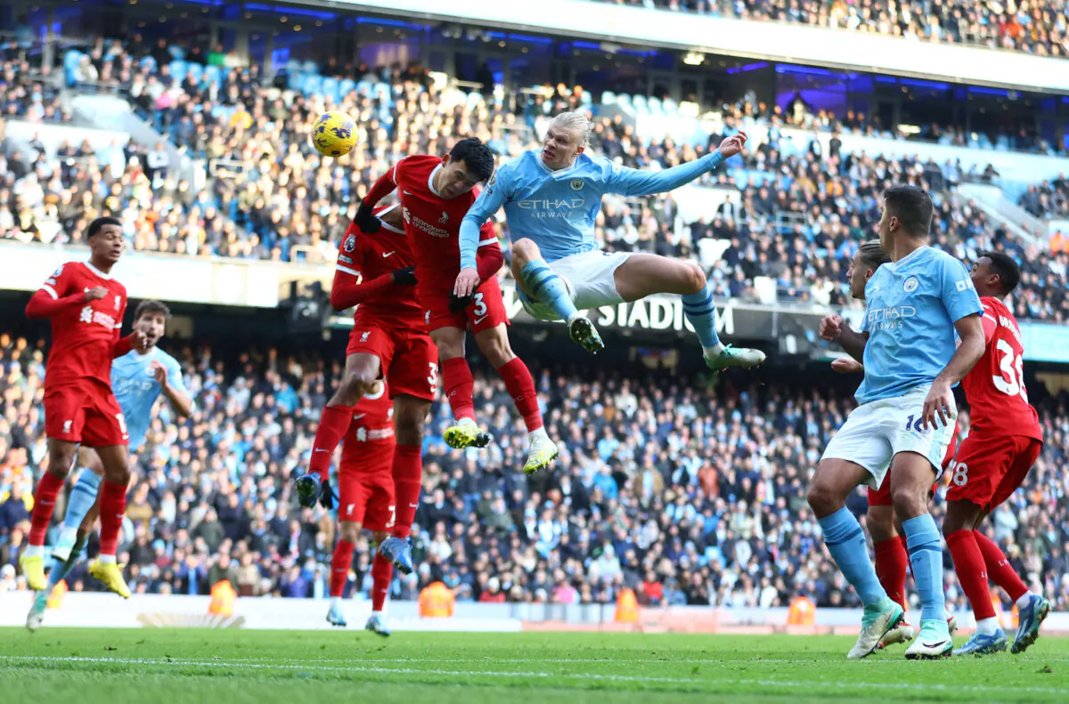 Manchester City's Erling Braut Haaland in action with Liverpool's Wataru Endo during the Premier League match between Manchester City and Liverpool FC at Etihad Stadium in Manchester, England, on Nov. 25, 2023. (Carl Recine/Reuters)