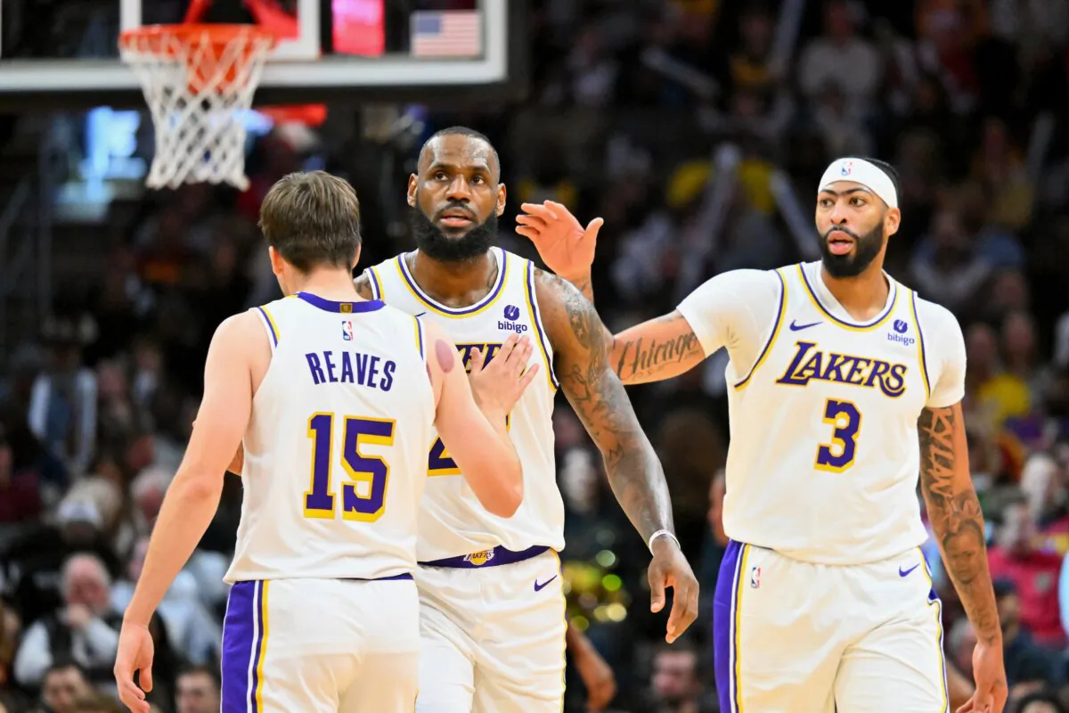Austin Reaves (15) and Anthony Davis (3) celebrate with LeBron James (23) of the Los Angeles Lakers during the third quarter against the Cleveland Cavaliers in Cleveland on Nov. 25, 2023. (Jason Miller/Getty Images)