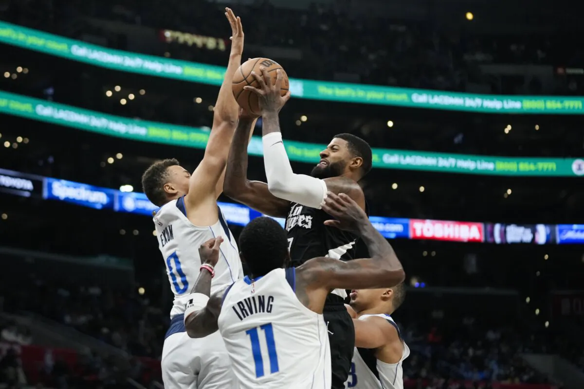 Los Angeles Clippers' Paul George shoots as Dallas Mavericks' Dante Exum (L) and Kyrie Irving defend during the second half of an NBA basketball game in Los Angeles on Nov. 25, 2023. (Jae C. Hong/AP Photo)