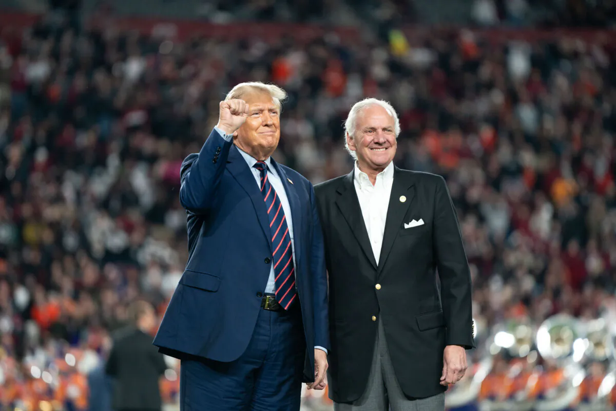 (L–R) Former President Donald Trump joins South Carolina Gov. Henry McMaster on the field during halftime in the Palmetto Bowl between Clemson and South Carolina at Williams Brice Stadium in Columbia, S.C., on Nov. 25, 2023. (Sean Rayford/Getty Images)