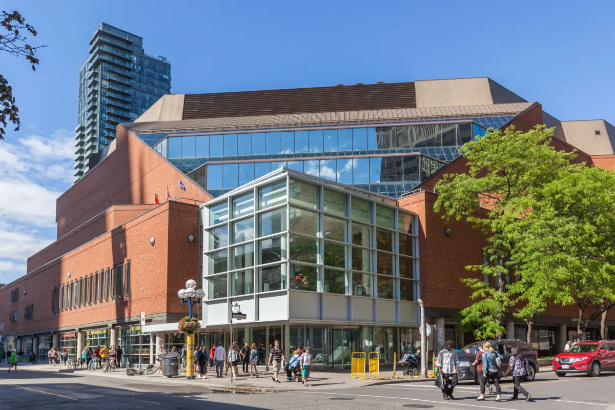 Pedestrians walk past the Toronto Reference Library, the largest branch of the Toronto Public Library, in downtown Toronto on June 25, 2017. (JHVEPhoto/Shutterstock)