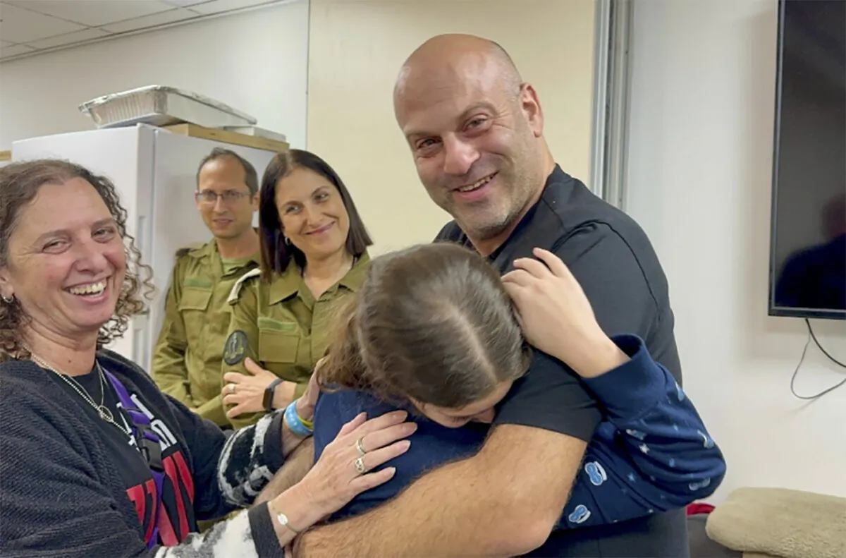Hila Rotem Shoshani, a released hostage, reunites with her uncle in Israel on Nov. 26, 2023. (The Israeli Army via AP)