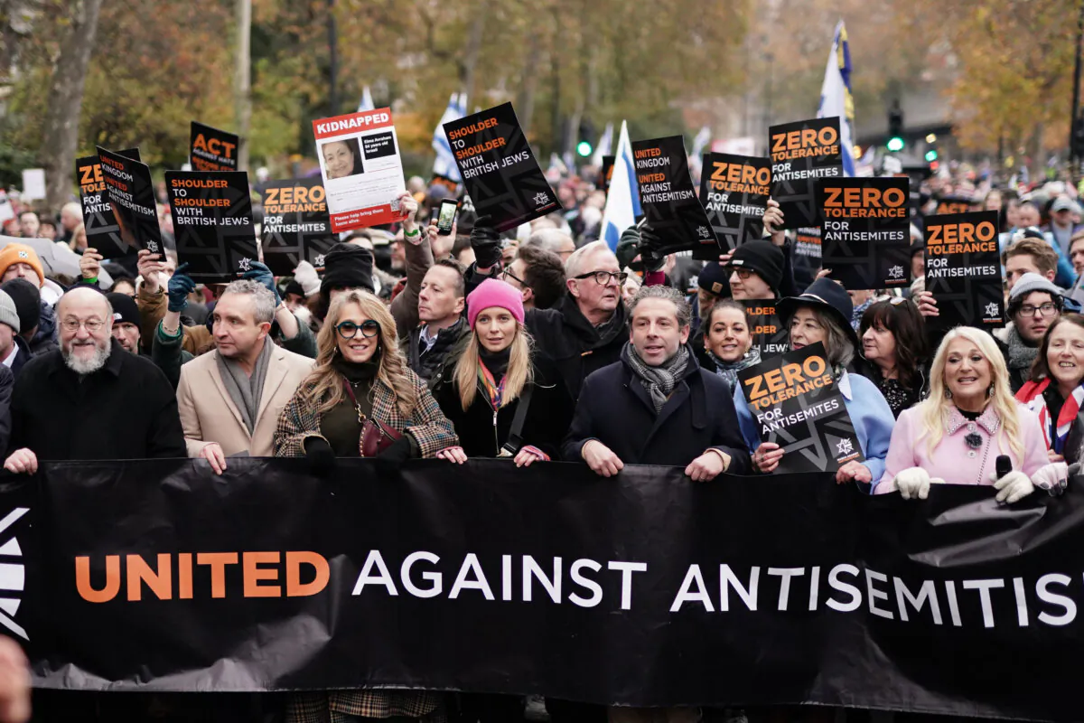 Demonstrators (L to R, the chief rabbi, Sir Ephraim Mirvis, Eddie Marsan, Tracy-Ann Oberman, Rachel Riley, Maureen Lipman, unknown man, and Vanessa Feltz take part in a march against anti-Semitism on Nov. 26, 2023. (Jordan Pettitt/PA Wire)