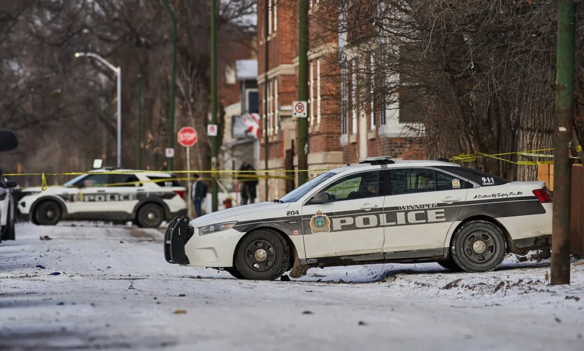 Police secure a crime scene where multiple people were killed in the 100 block of Langside Street in Winnipeg on Nov. 26, 2023. (The Canadian Press/David Lipnowski)