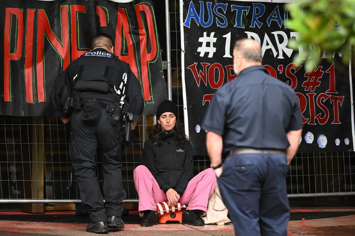 Police officers work to remove a protester at protest outside of the United States Consulate in Melbourne, Australia, on Nov. 27, 2023. (AAP Image/James Ross) 