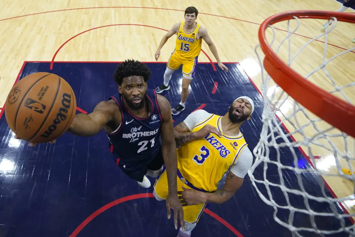 Philadelphia 76ers' Joel Embiid (L) goes up for a shot past Los Angeles Lakers' Anthony Davis during the first half of an NBA basketball game in Philadelphia on Nov. 27, 2023. (Matt Slocum/AP Photo)