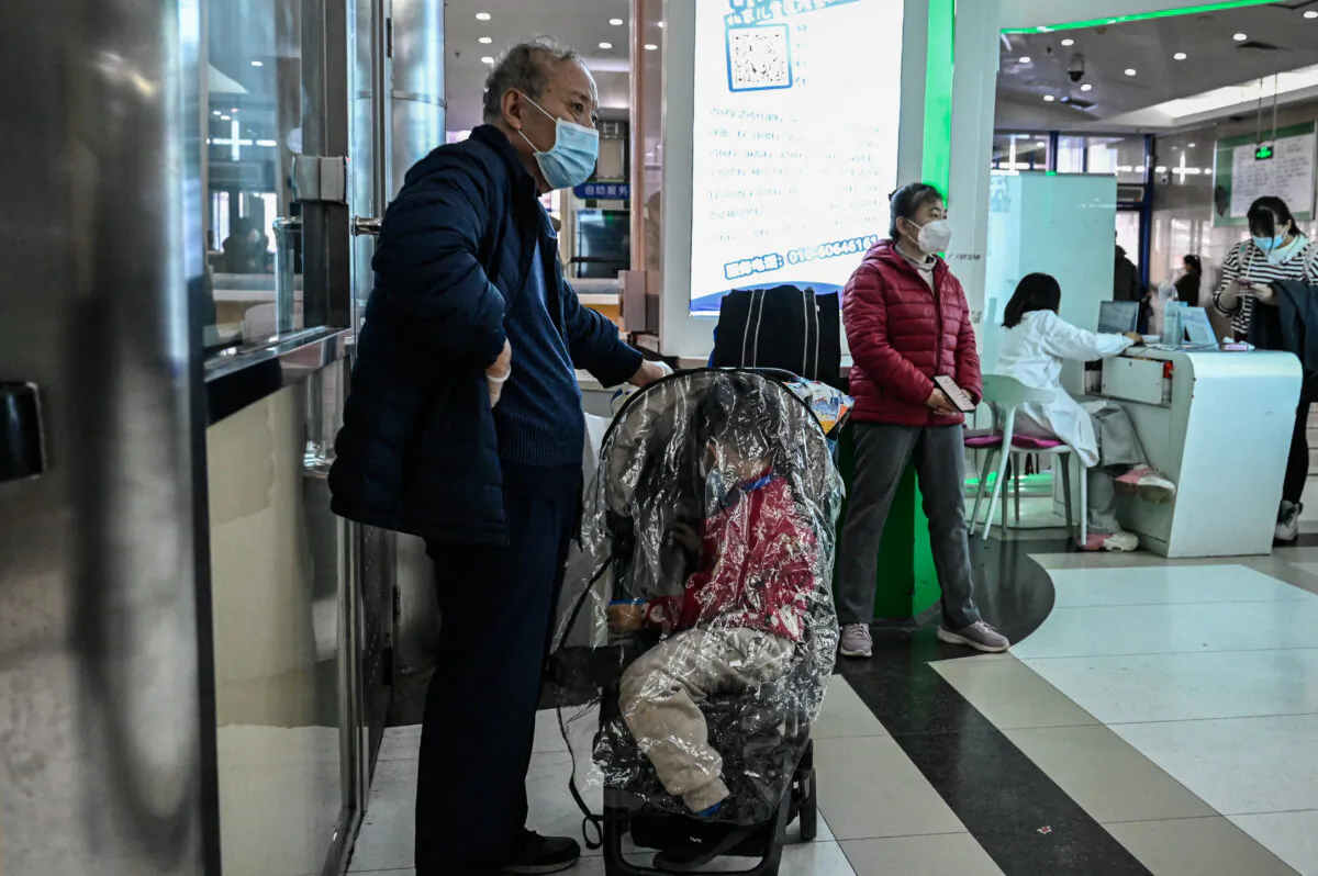 Children and their parents wait at an outpatient area at a children's hospital in Beijing on Nov. 23, 2023. (Jade Gao/AFP via Getty Images)
