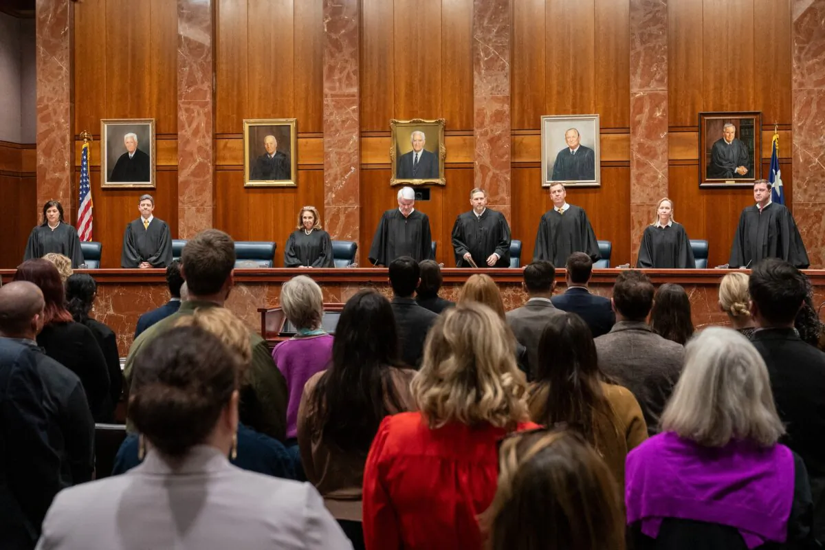 (L-R) Justice Rebeca Aizpuru Huddle, Justice Brett Busby, Justice Debra Lehrmann, Chief Justice Nathan L. Hecht, Justice Jeff Boyd, Justice Jimmy Blacklock, Justice Jane Bland, and Justice Evan A. Young, of the Texas Supreme Court, arrive to hear litigators make their arguments at the Texas Supreme Court in Austin, Texas, on Nov. 28, 2023. (Suzanne Cordeiro/AFP/Getty Images)