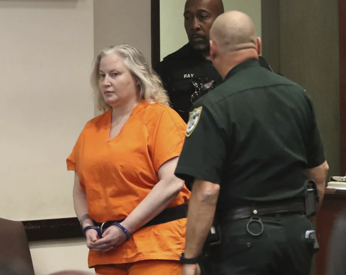 WWE Hall of Famer Tammy Sytch is escorted to the defense table by Volusia Couty Sheriff's bailiffs for her sentencing at the S. James Foxman Justice Center in Daytona Beach, Fla., on Nov. 27, 2023, for a DUI crash that killed a man in 2022. (David Tucker/The Daytona Beach News-Journal via AP, Pool)