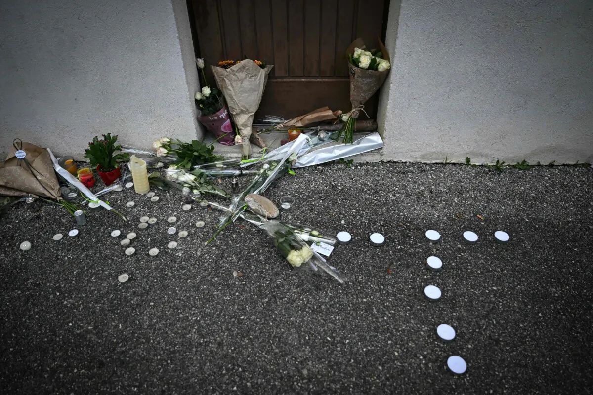 Flowers and candles in front of the reception hall where Thomas, a teenager, passed away on Nov. 19, 2023, after being wounded with a knife during a ball in the small village in the Drome region, in Crepol, southeastern France, on Nov. 22, 2023. (Olivier Chassignole/AFP via Getty Images)