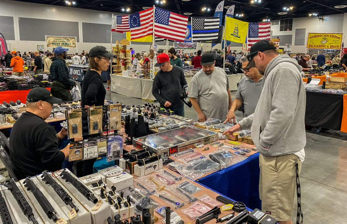 Shoppers browse among firearms and accessories at the Crossroads of the West Gun Show at the Convention Center in Ontario, Calif., on Jan. 28, 2023. (Apu Gomes/AFP via Getty Images)