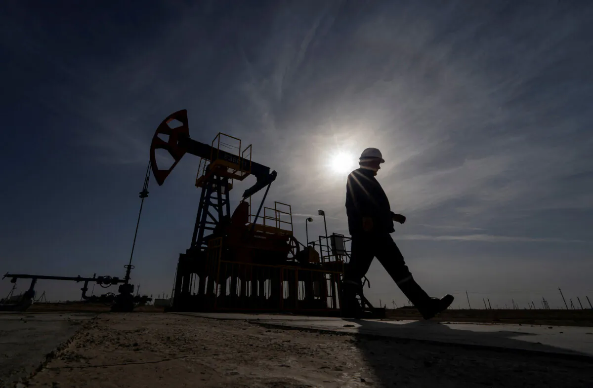 An oil and gas industry worker walks during operations of a drilling rig at Zhetybay field in the Mangystau region, Kazakhstan, on Nov. 13, 2023. (Turar Kazangapov/Reuters)