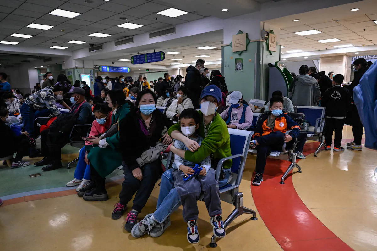 Children and their parents wait at an outpatient area at a children hospital in Beijing on Nov. 23, 2023. (Jade Gao/AFP)