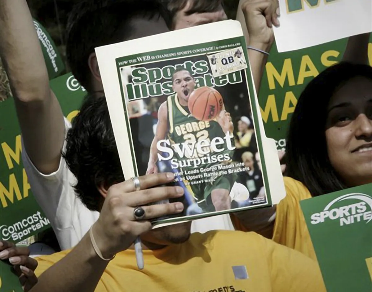 A George Mason University fan holds up a Sports Illustrated magazine at a send off for the team in Fairfax, Va., on March 29, 2006. (Lawrence Jackson/AP Photo)