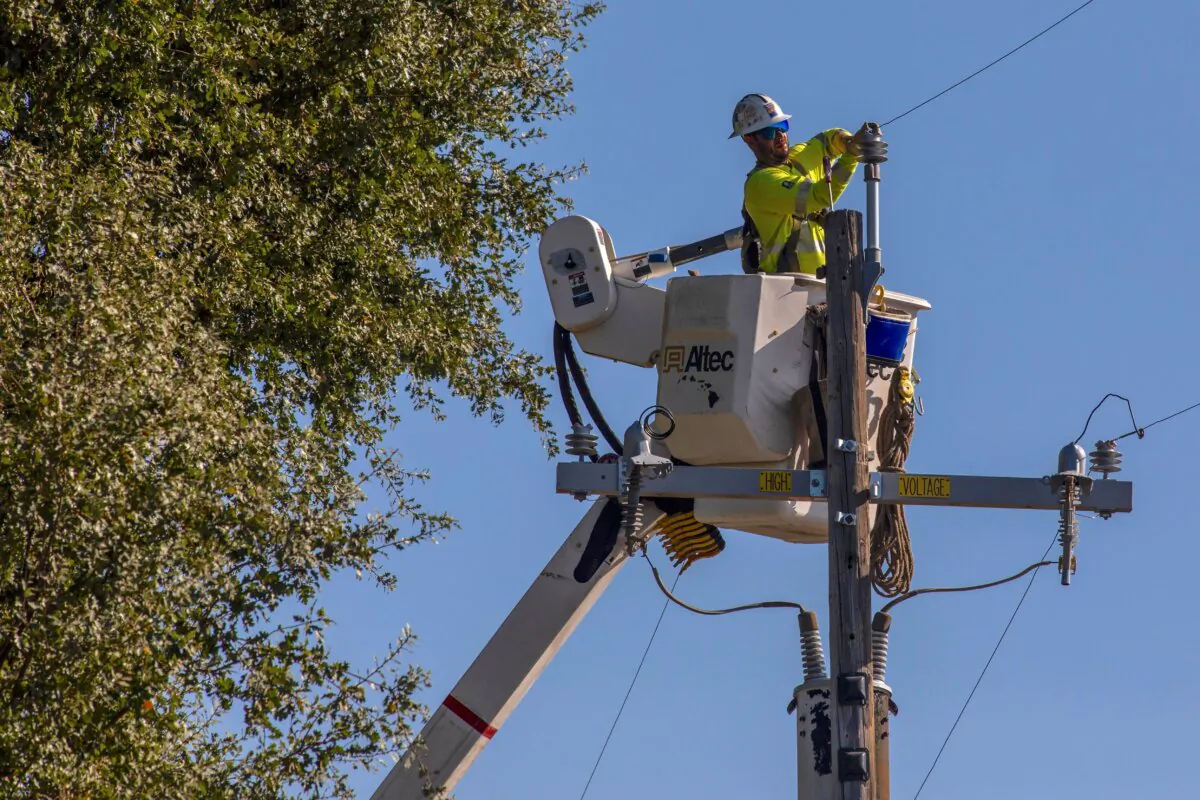 A PG&E contractor works on utility poles along Highway 128 near Geyserville, Calif., on Oct. 31, 2019. (Philip Pacheco/AFP via Getty Images)