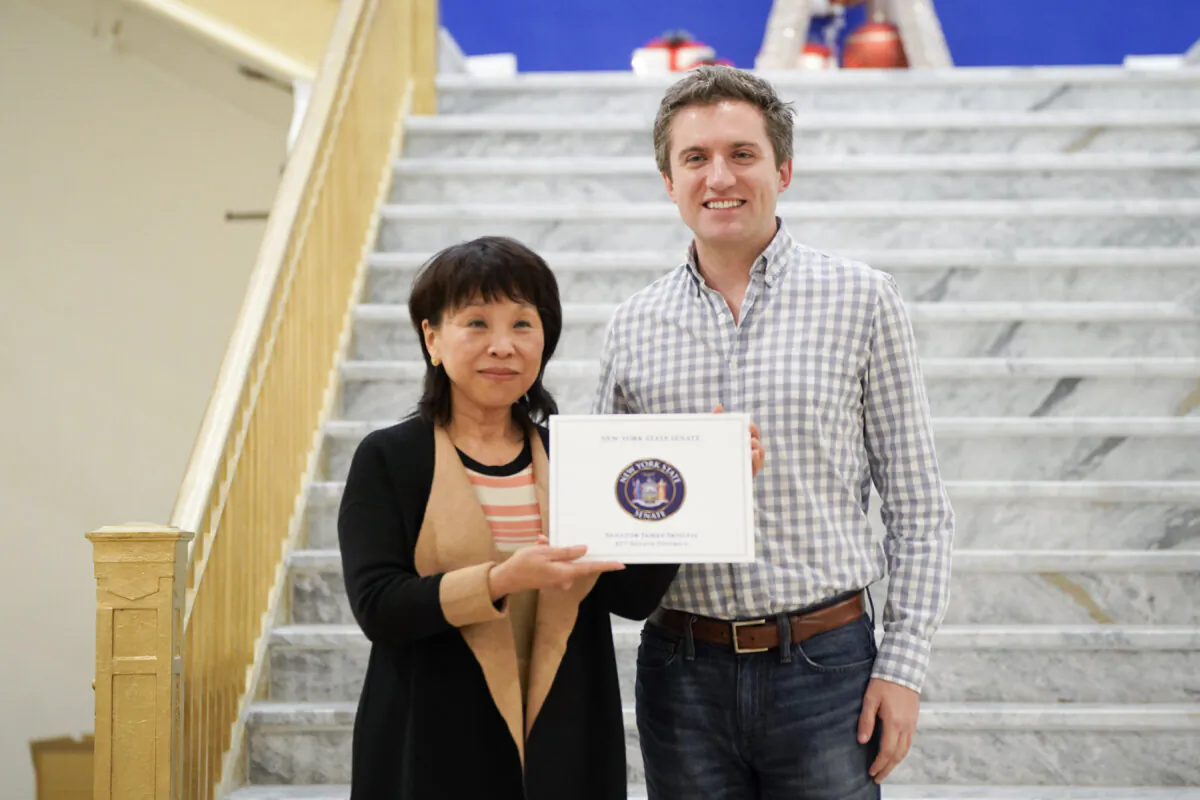 New Middletown CEO Lili Zhou (L) accepts a certificate from Sen. James Skoufis (D-N.Y.) in Middletown, N.Y., on Nov. 29, 2023. (Cara Ding/The Epoch Times)