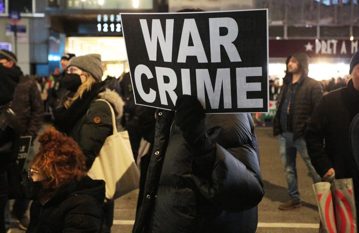 Pro-Palestinian protesters held various signs aloft during their demonstration outside the Fox News building on 6th Ave in Midtown Manhattan on Nov. 29, 2023. (Richard Moore/The Epoch Times)