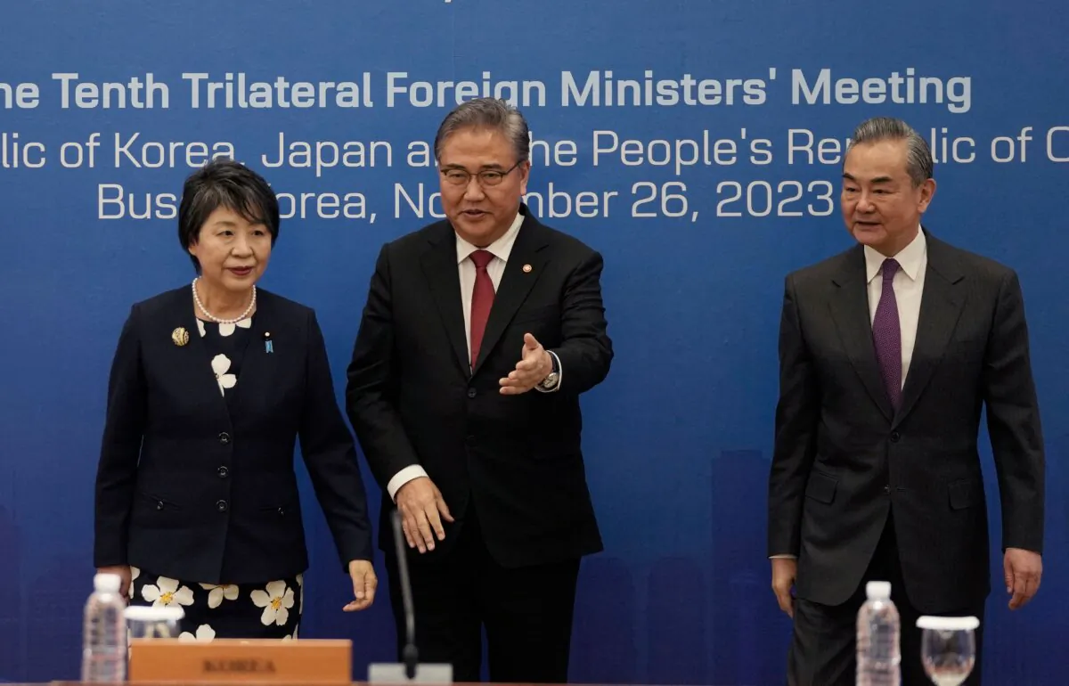 (L-R) Japanese Foreign Minister Yoko Kamikawa, South Korean Foreign Minister Park Jin, and Chinese Foreign Minister Wang Yi arrive for the 10th trilateral foreign ministers' meeting in Busan on Nov. 26, 2023. (Ahn Young-Joon/POOL/AFP via Getty Images)