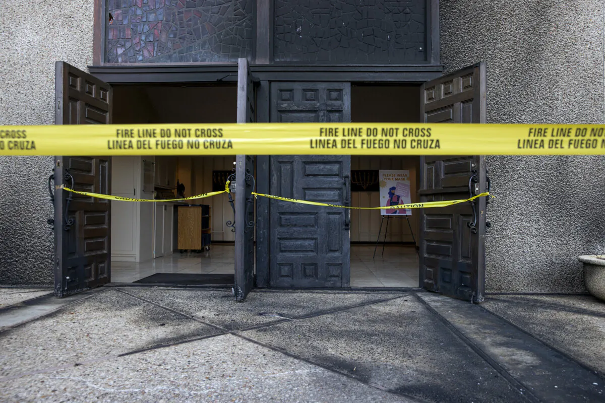 Caution tape marks the front doors at Congregation Beth Israel on Nov. 1, 2021, after someone started a fire at the Central Austin synagogue in Austin, Texas, the previous day. (Jay Janner/Austin American-Statesman via AP)