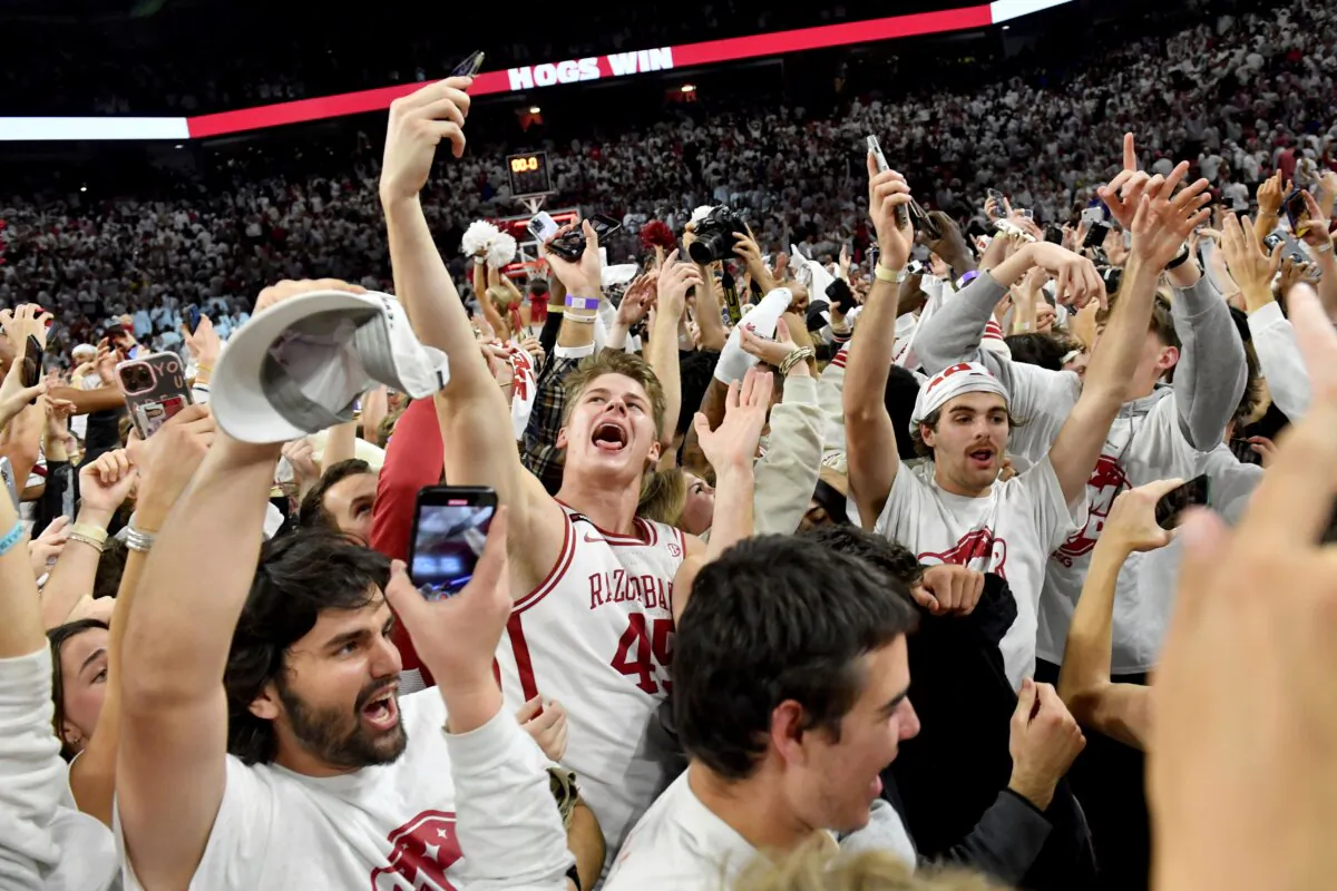 Arkansas' Lawson Blake (45) celebrates with fans after defeating Duke in an NCAA college basketball game in Fayetteville, Ark., on Nov. 29, 2023. (Michael Woods/AP Photo)