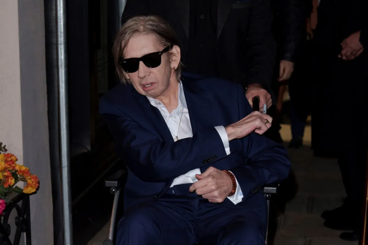 Shane MacGowan poses for photographers upon arrival at the Shane MacGowan, The Eternal Buzz & The Crock of Gold Exhibition in London, on Oct. 11, 2022. (Scott Garfitt/Invision/AP Photo)
