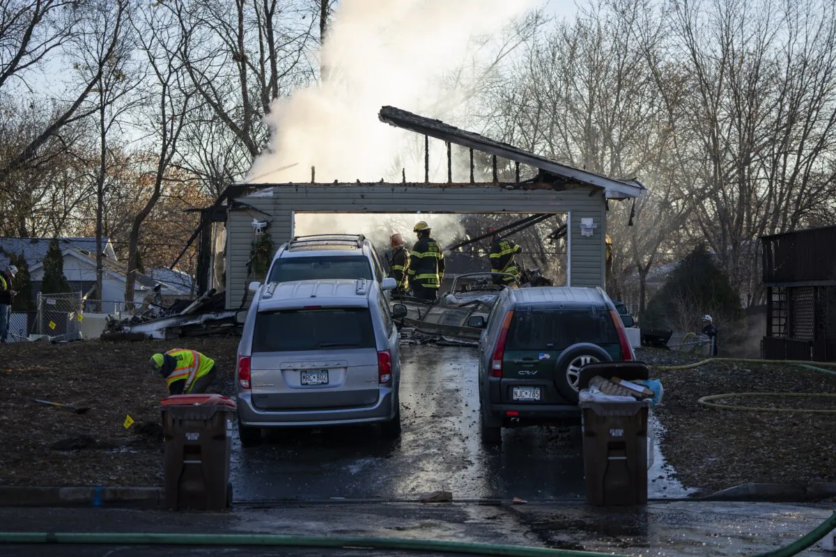 Fire crews work to put out a fire after a home exploded in South St. Paul on Nov. 30, 2023. (Leila Navidi/Star Tribune via AP)