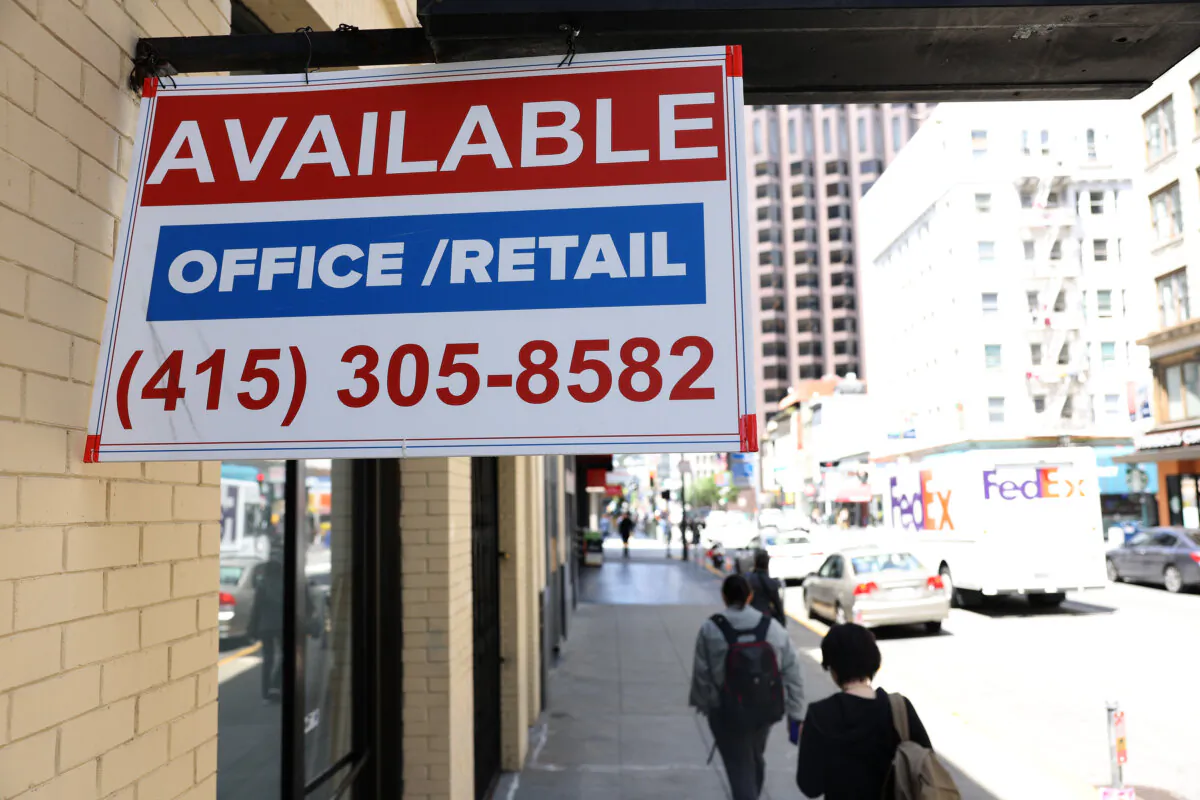 Pedestrians walk by an empty retail space in San Francisco on May 9, 2023. (Justin Sullivan/Getty Images)