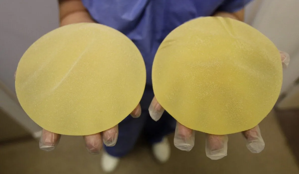 A nurse holds defective breast implants in Nice, southern France, on Jan.10, 2012. (The Canadian Press/AP-Lionel Cironneau)