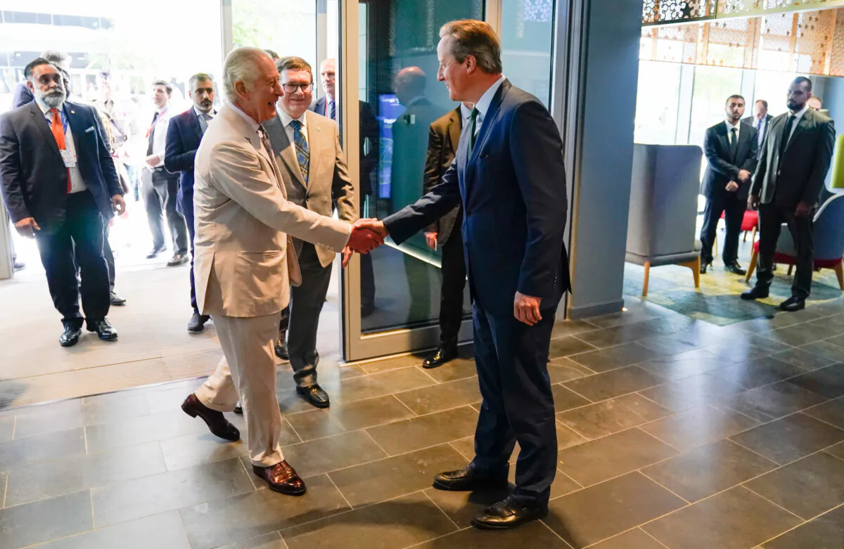 King Charles III is greeted by Foreign Secretary Lord David Cameron as part of COP28 during a visit to Heriot-Watt University's Dubai campus on Nov. 30, 2023. (Andrew Matthews/PA Wire)