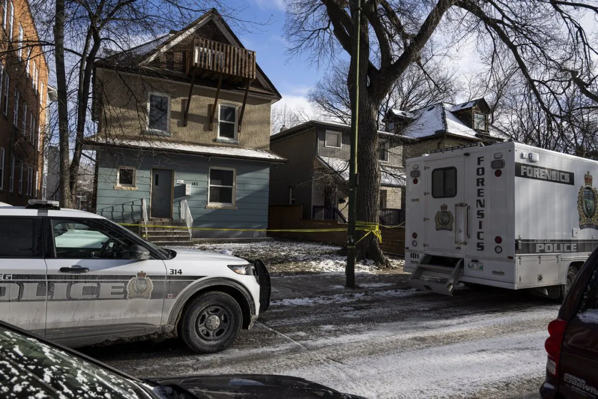 Police vehicles are shown outside the scene of a shooting at a home in Winnipeg on Nov. 27, 2023. (The Canadian Press/Aaron Vincent Elkaim)