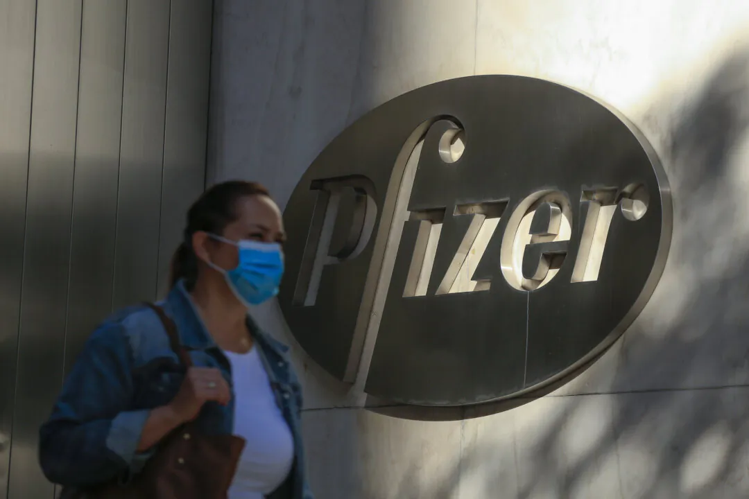 A woman walks by Pfizer's headquarters in New York City in a file image. (Kena Betancur/AFP via Getty Images)