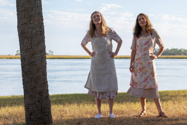 two women standing next to a tree in MAY DECEMBER