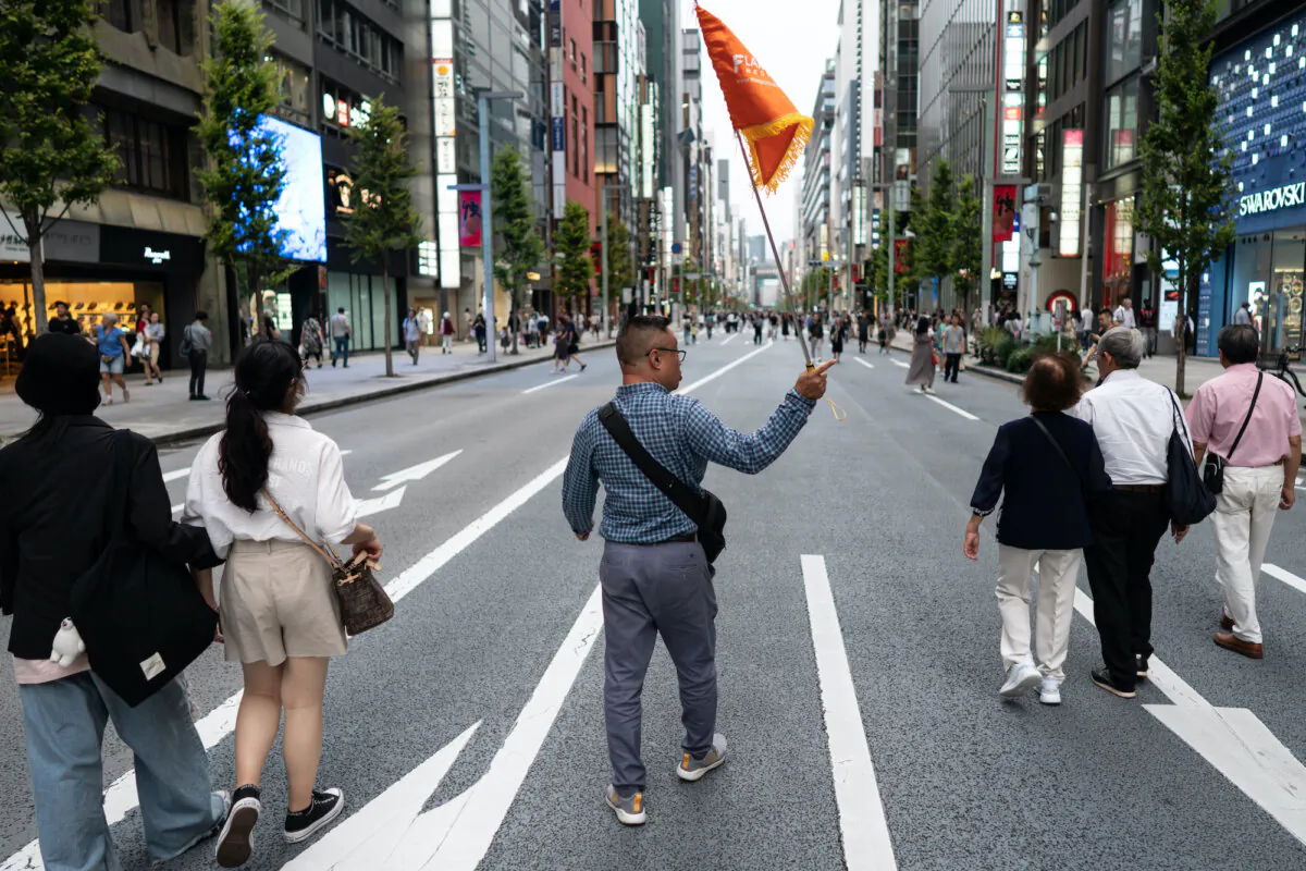 A group of Chinese tourists walks through the Ginza district during the China's National Day holiday in Tokyo, Japan on Oct. 1, 2023. (Tomohiro Ohsumi/Getty Images)