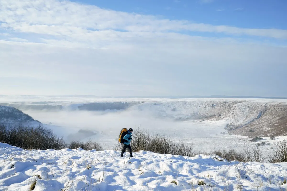 A person walks through snow above the Hole of Horcum at the North York Moors National Park in north-eastern Yorkshire, England, on Dec. 2, 2023. (Danny Lawson/PA Wire)