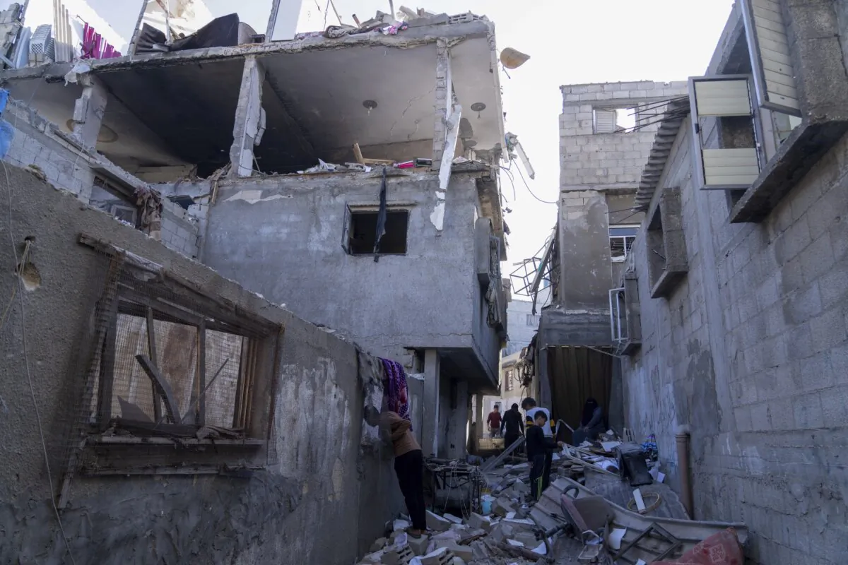 Palestinians inspect a damaged building following Israeli airstrikes on the town of Khan Younis, Gaza, on Dec. 3, 2023. (Fatima Shbair/AP Photo)