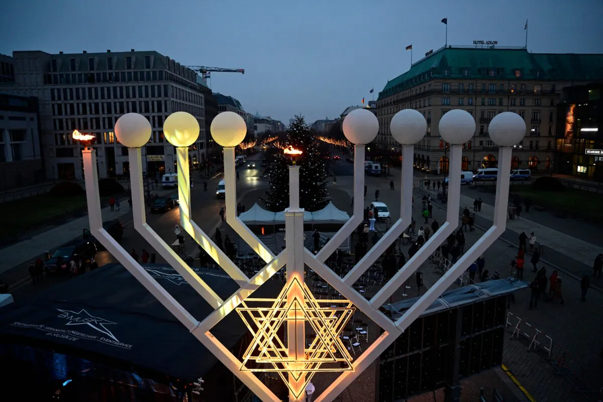 A photo taken from a lifting platform shows a view on a large menorah candelabra after the first flames were lit to celebrate the Chanukah festival, in front of the Brandenburg Gate in Berlin, on Dec. 18, 2022. (John MacDougall/AFP via Getty Images)