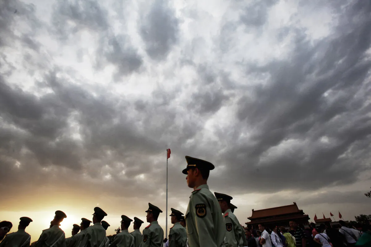 Paramilitary police officers patrol Tiananmen Square outside the Forbidden City, which was the Chinese imperial palace from the mid-Ming Dynasty to the end of the Qing Dynasty, in Beijing on May 18, 2011. (Feng Li/Getty Images)