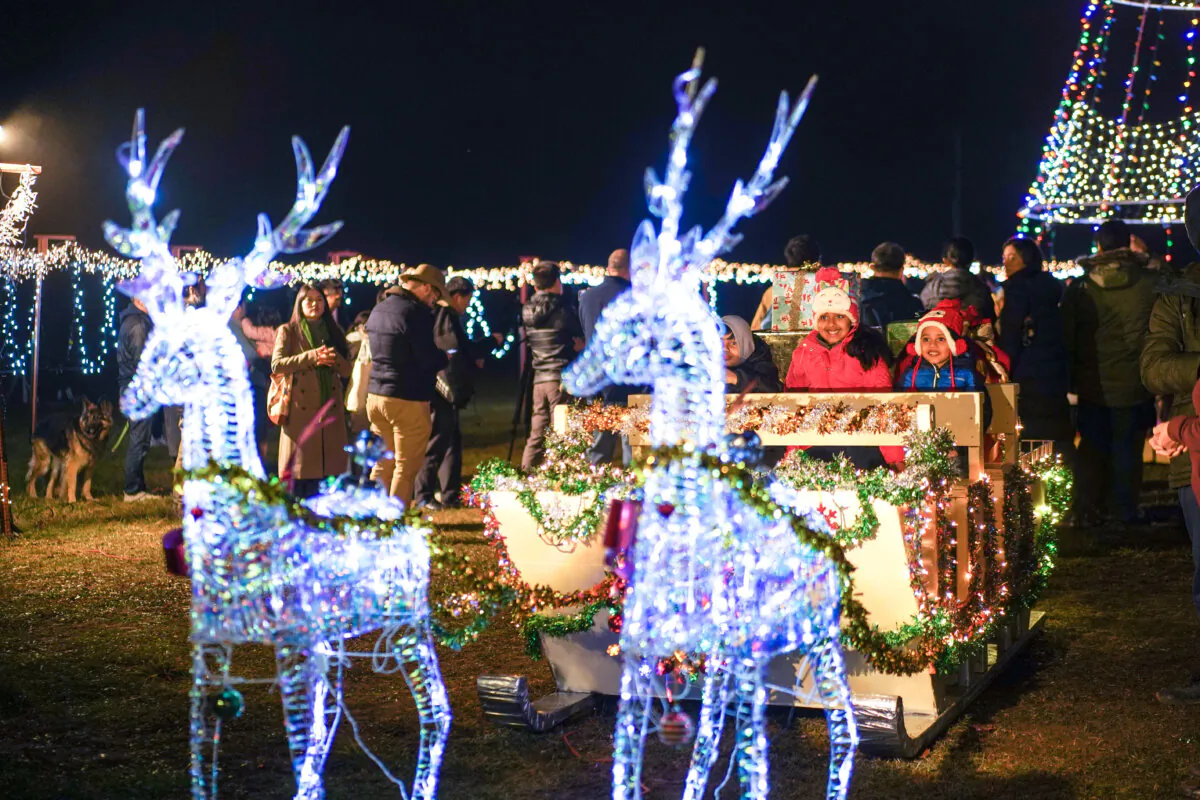 Children ride in a sleigh at New Century in the Town of Deerpark, N.Y., on Dec. 2, 2023. (Cara Ding/The Epoch Times)