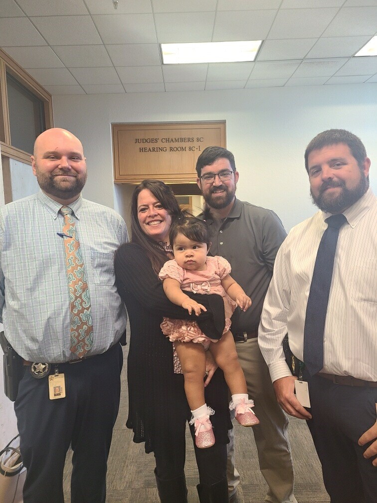 Angel Grace with her adoptive parents.