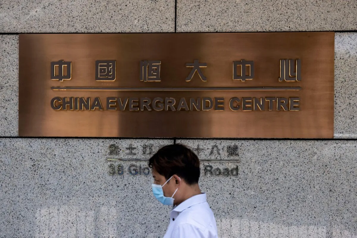A man walks past the China Evergrande Centre in Hong Kong on July 28, 2022. (Isaac Lawrence/AFP via Getty Images)