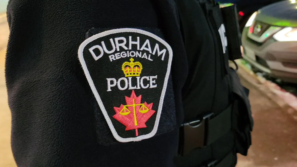 A Durham Regional Police officer's logo emblem is shown at a Bowmanville, Ont., shopping centre parking lot on Feb. 28, 2023. (The Canadian Press/Doug Ives)