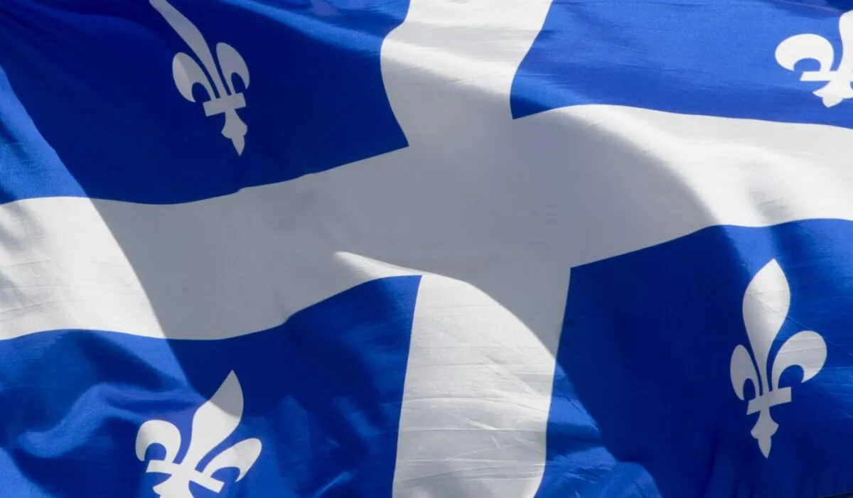 Quebec's provincial flag flies on a flagpole in Ottawa on June 30, 2020. (The Canadian Press/Adrian Wyld)