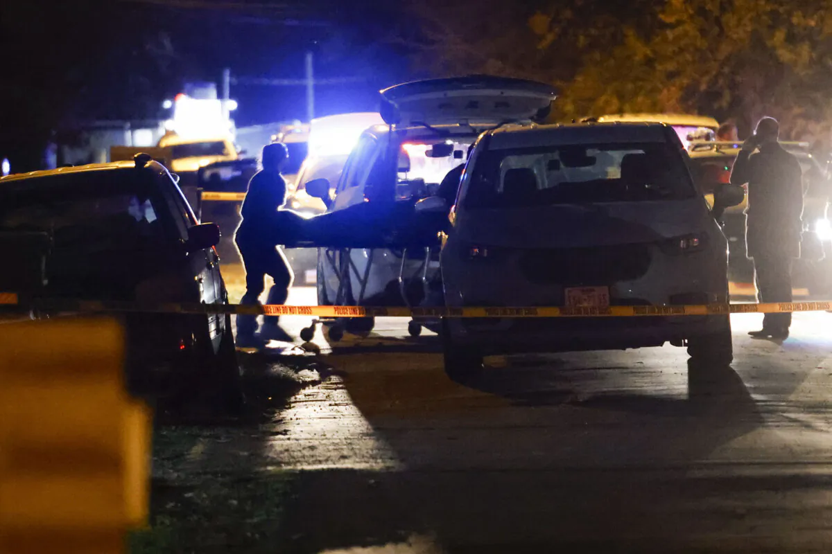Authorities transport a stretcher at the scene of a homicide in Dallas on Dec. 3, 2023. (Shafkat Anowar/The Dallas Morning News via AP)