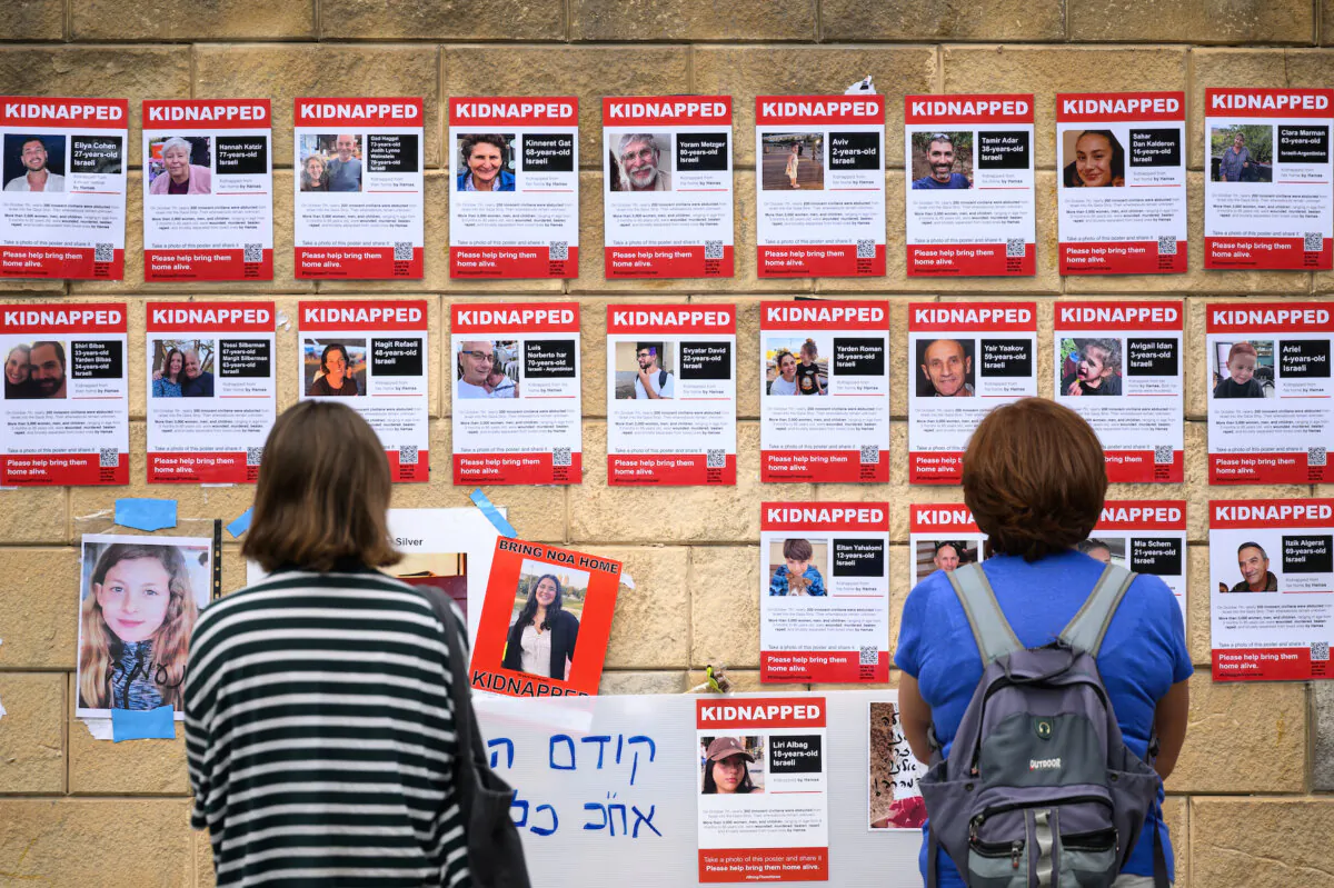 Photographs of some of those taken hostage by Hamas during their recent attacks are seen in Tel Aviv, Israel, on Oct. 18, 2023. (Leon Neal/Getty Images)