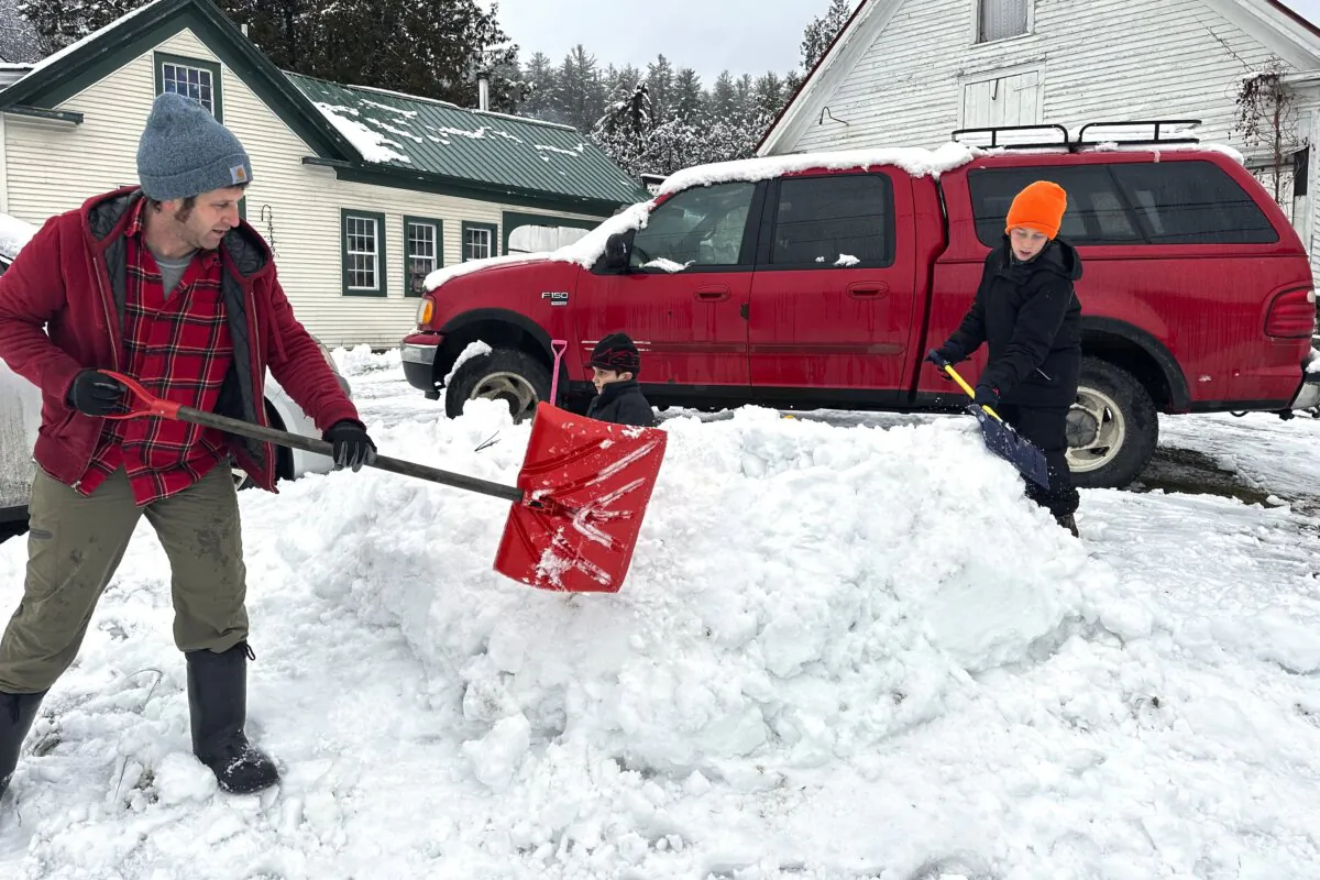 Dave Torres (L), Till Graves (C), and Henry Torres (R) build a snow cave in Marshfield, Vt., on Dec. 4, 2023. (Lisa Rathke/AP Photo)