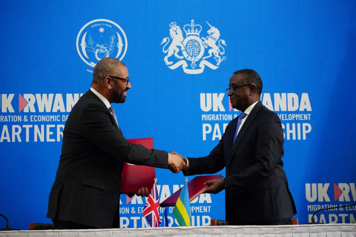 British Foreign Secretary James Cleverly (L) and Rwanda's foreign minister Vincent Biruta (R) shake hands after signing a treaty in Kigali, Rwanda, on Dec. 5, 2023. (PA)