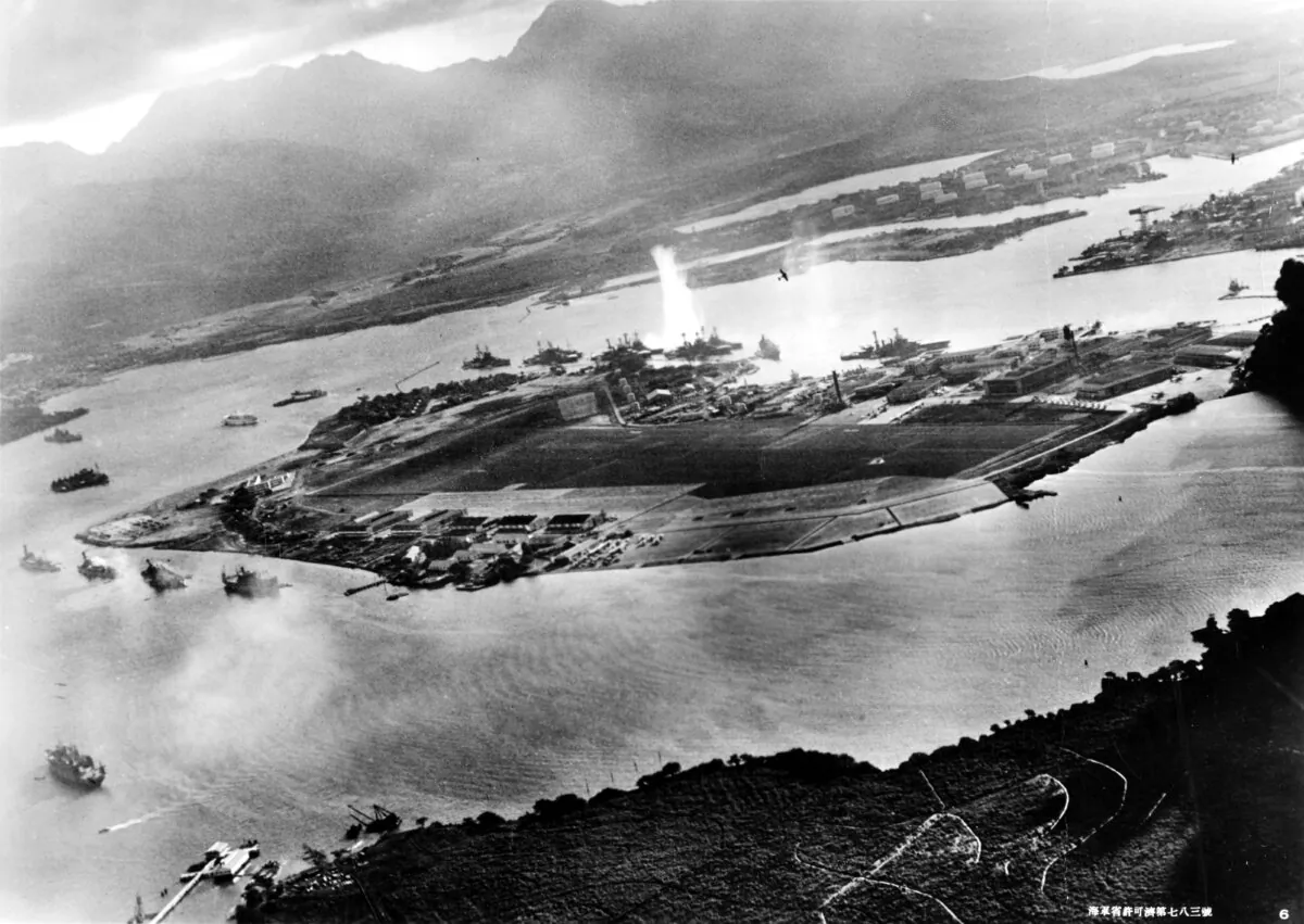 Photograph taken from a Japanese plane during the torpedo attack on ships moored on both sides of Ford Island shortly after the beginning of the Pearl Harbor attack. U.S. Navy. (Public Domain)