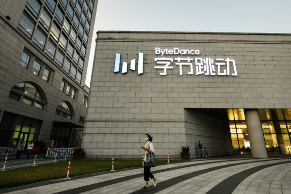 A woman walks past the headquarters of ByteDance, the parent company of video sharing app TikTok, in Beijing on September 16, 2020. - Silicon Valley tech giant Oracle is "very close" to sealing a deal to become the US partner to Chinese-owned video app TikTok to avert a ban in the United States, President Donald Trump said on September 15. (Photo by GREG BAKER / AFP) (Photo by GREG BAKER/AFP via Getty Images)