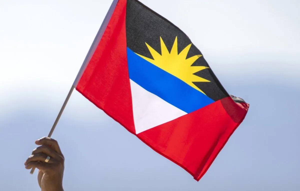 A person holds a flag of Antigua and Barbuda near Truth or Consequences, N.M., Aug. 10, 2023. (The Canadian Press/AP, Andrés Leighton)