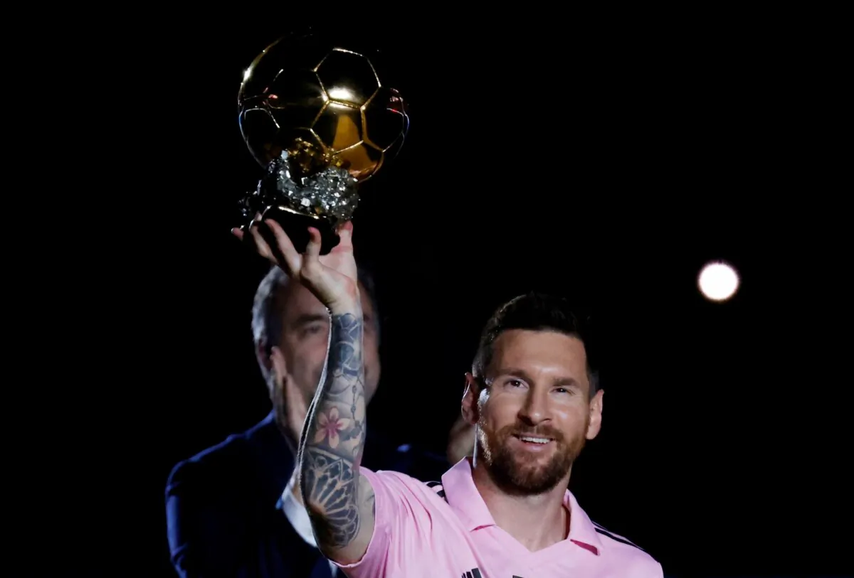 Lionel Messi poses with his eighth Ballon d'Or during the Noche d'Or ceremony ahead of the match in DRV PNK Stadium, Fort Lauderdale, Fla., on Nov. 10, 2023. (Marco Bello/Reuters)